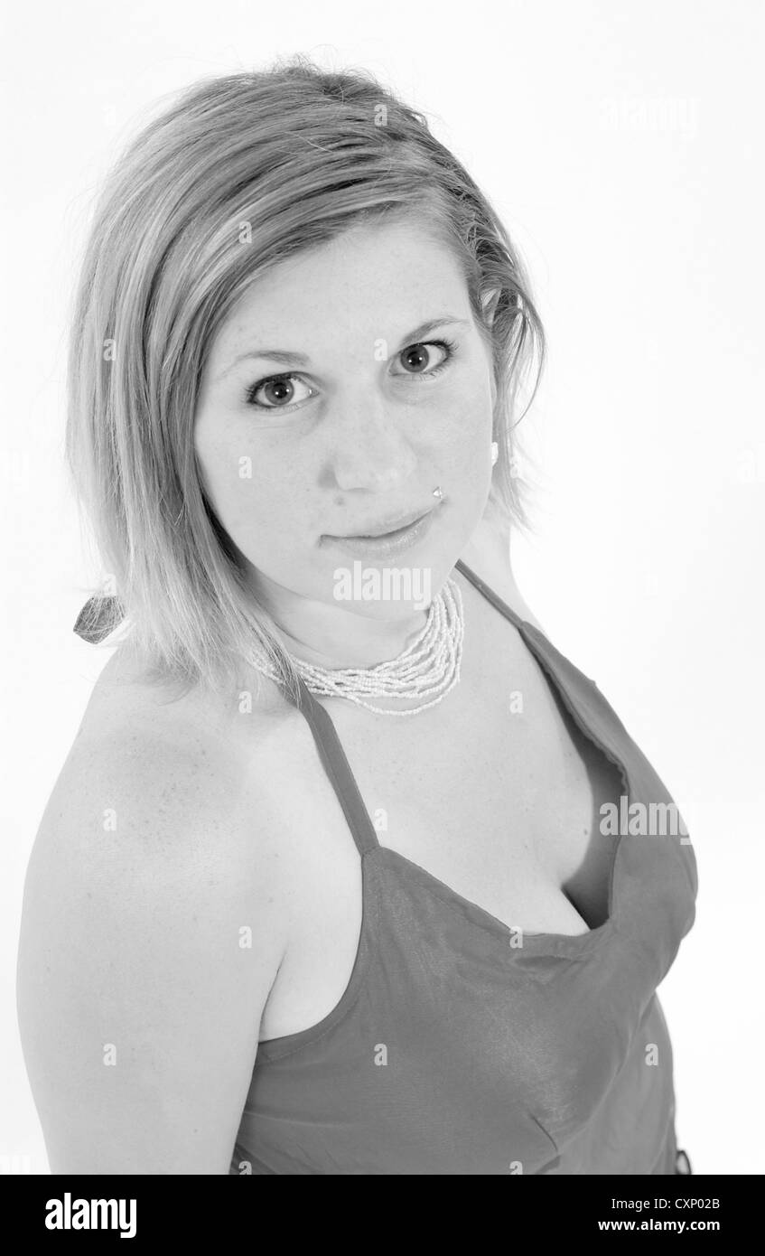 Giovane biondo busty woman in fashion shoot indossando un top rosa Foto Stock