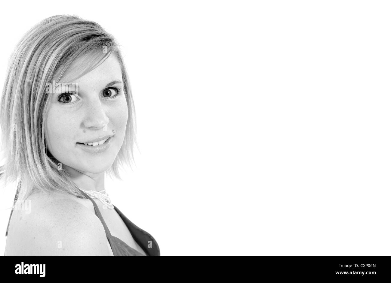 Giovane biondo busty woman in fashion shoot indossando un top rosa Foto Stock