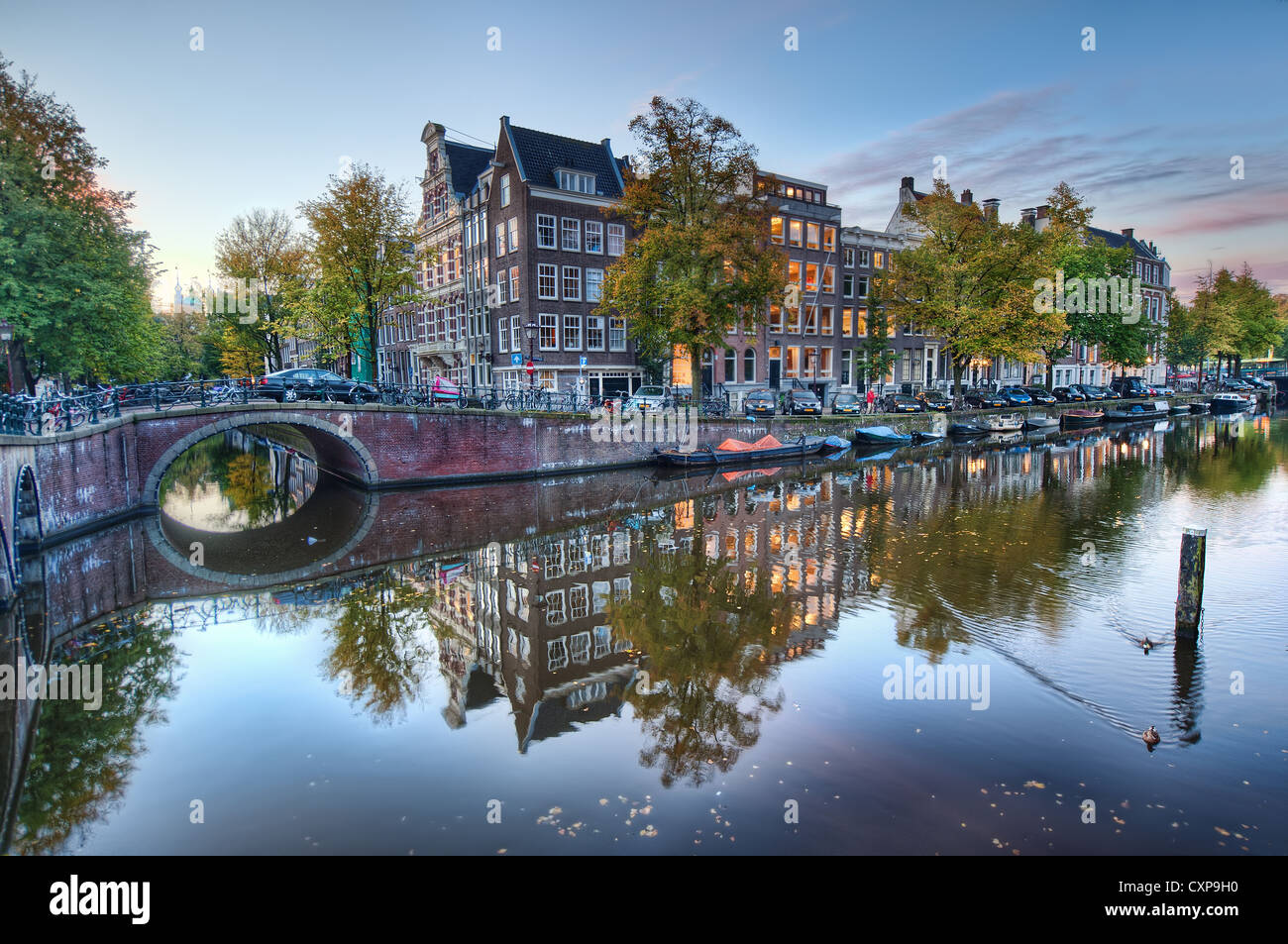 Amsterdam canal case sono riflessi nell'acqua nella quiete della mattina presto Foto Stock