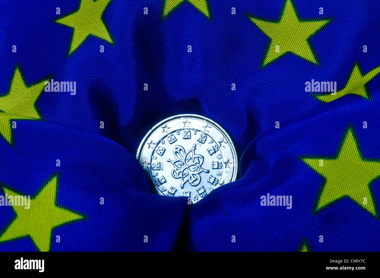 Il portoghese euro moneta giacente su una bandiera europea, andando verso il basso, immagine simbolica Foto Stock