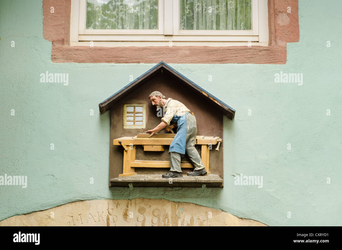 Simbolo di artigianato di un carpentiere o falegname sopra lo sportello anteriore di una vecchia casa nella città vecchia di Freiburg im Breisgau Foto Stock