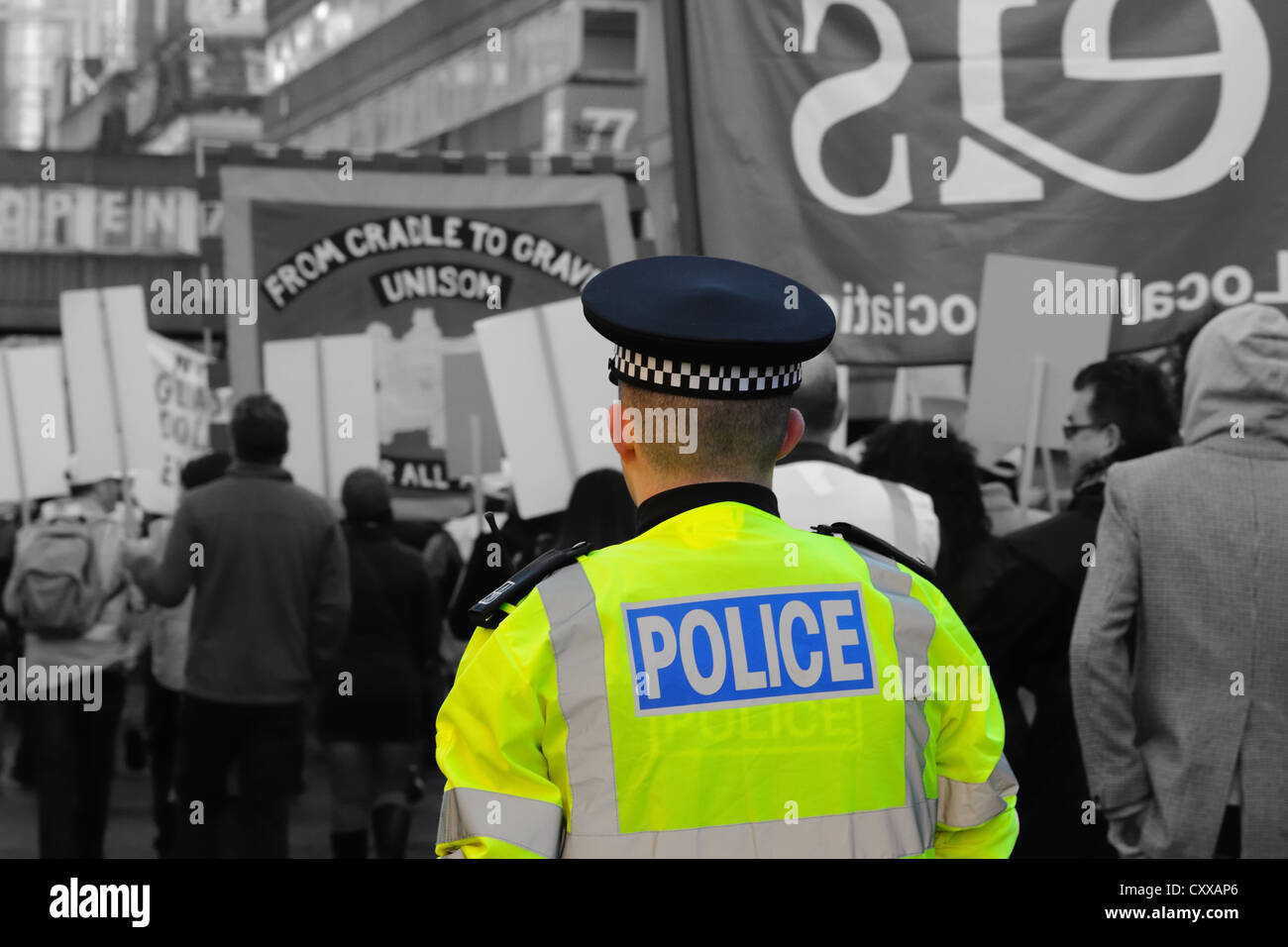 Polizia scozzese constable supervisionare un politico nel marzo del Regno Unito. Colorazione selettiva di tecnica applicata a hi viz giacca. Foto Stock