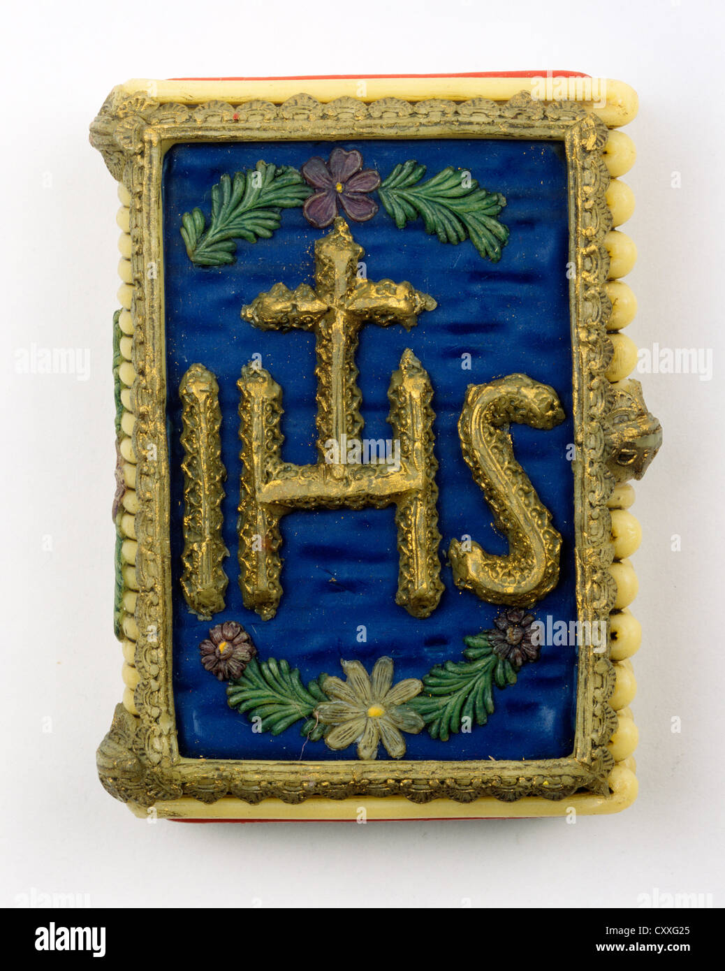 Conicità di cera a forma di libro con il simbolo di Gesù Cristo, IHS Foto Stock