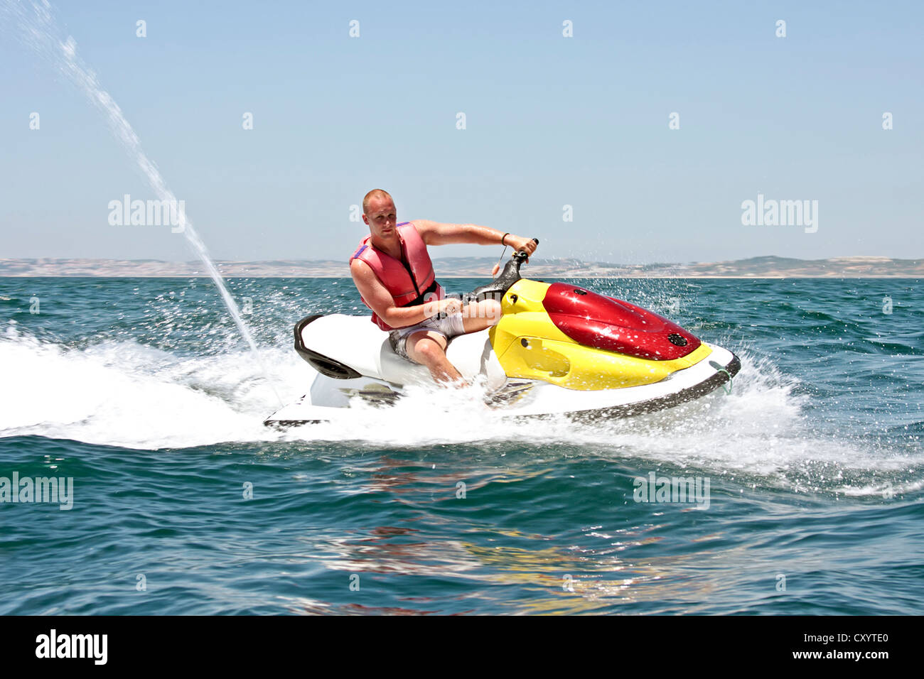 Giovane ragazzo la crociera sull'Oceano Atlantico su un jet ski Foto Stock