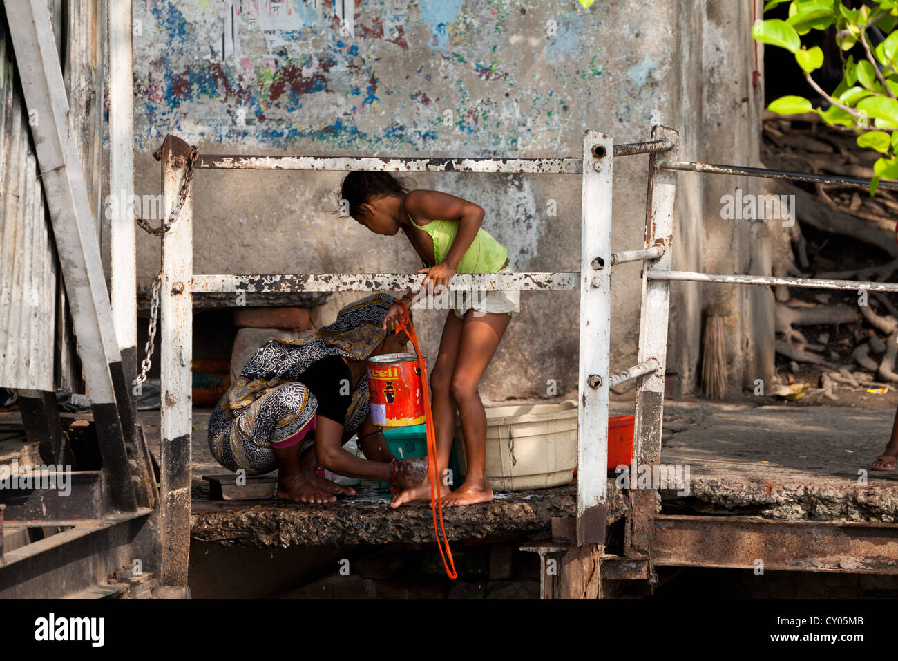 La madre e la sorella facendo Servizio lavanderia sulle rive del fiume in Kolkata, India Foto Stock