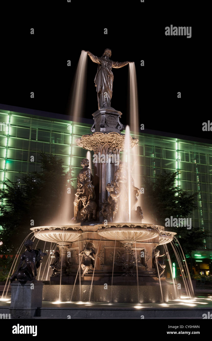 Il Genius di acqua statua in Piazza Fontana, Cincinnati a notte con green building Foto Stock