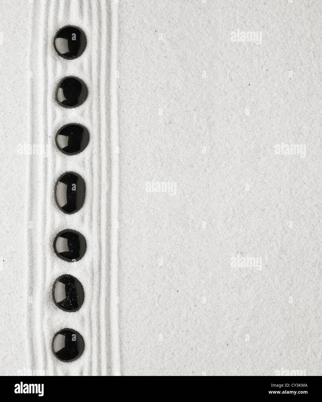 Pietre Nere in sabbia Foto Stock