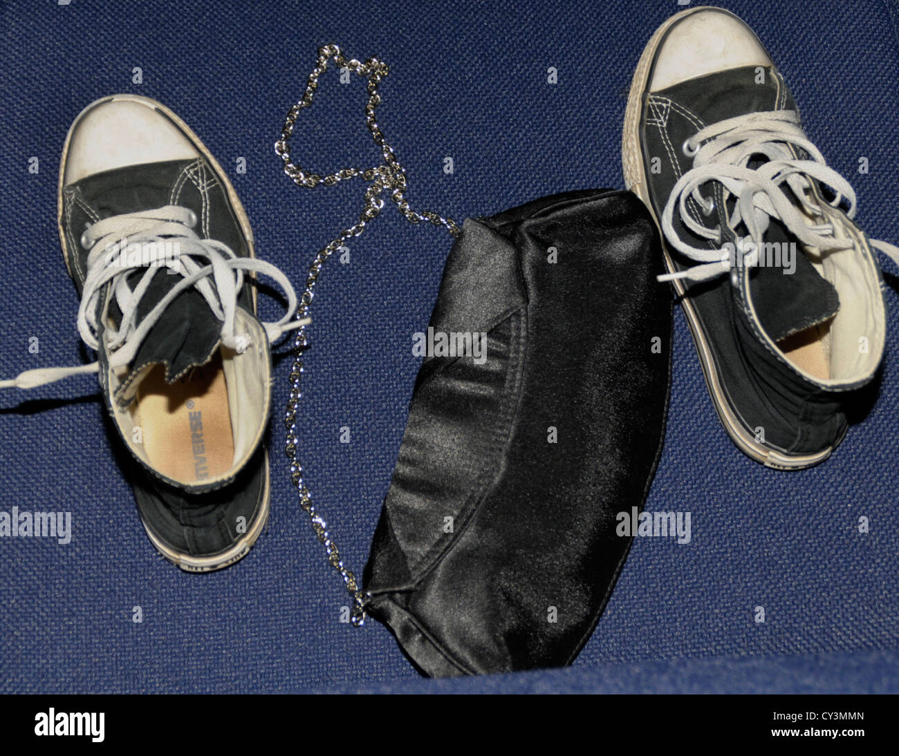 2 scarpe da tennis e una borsa abbandonata sul pavimento di un salone da ballo Foto Stock