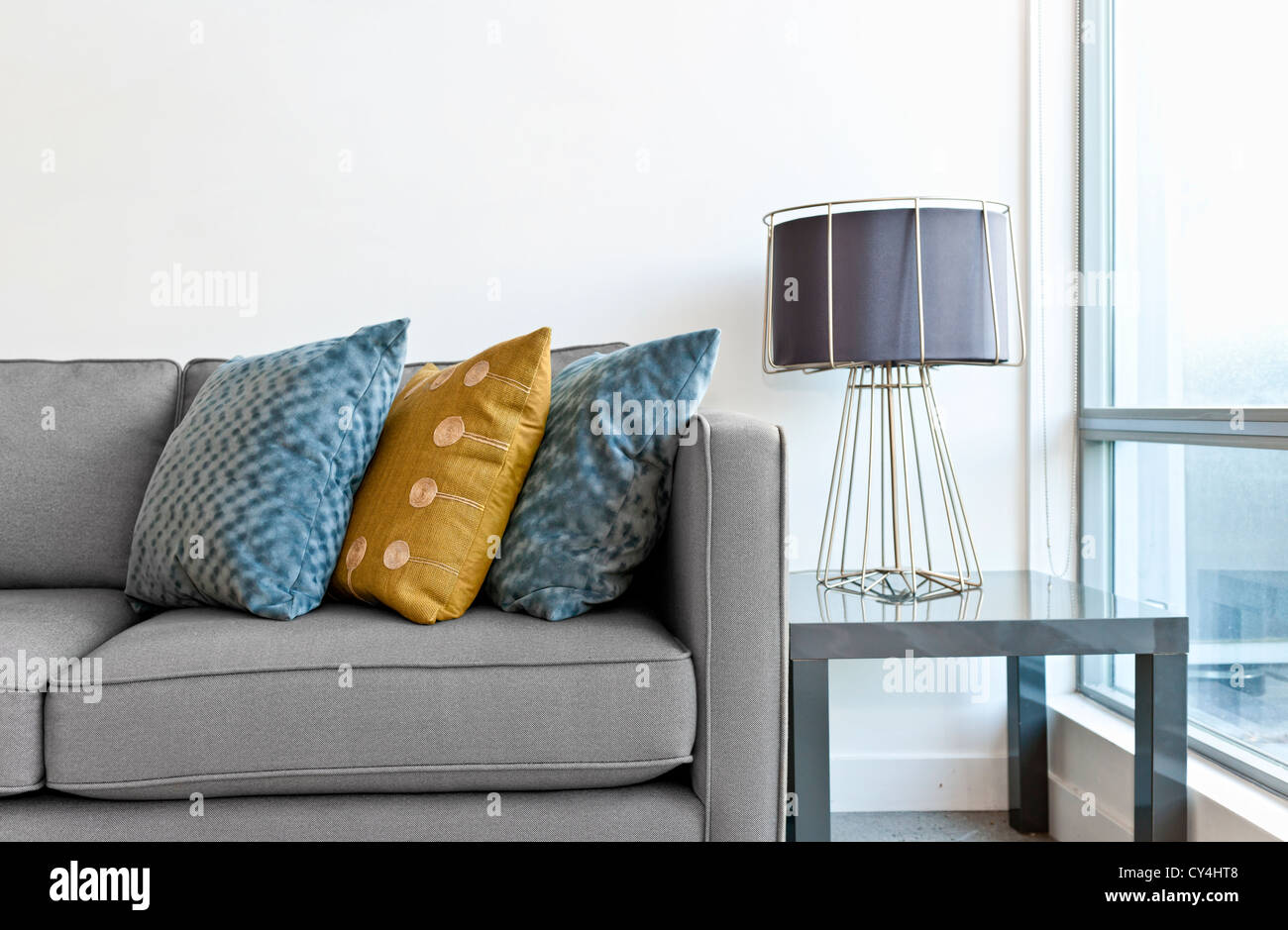 Il design degli interni con lettino, cuscini colorati e la lampada sul tavolo finale Foto Stock