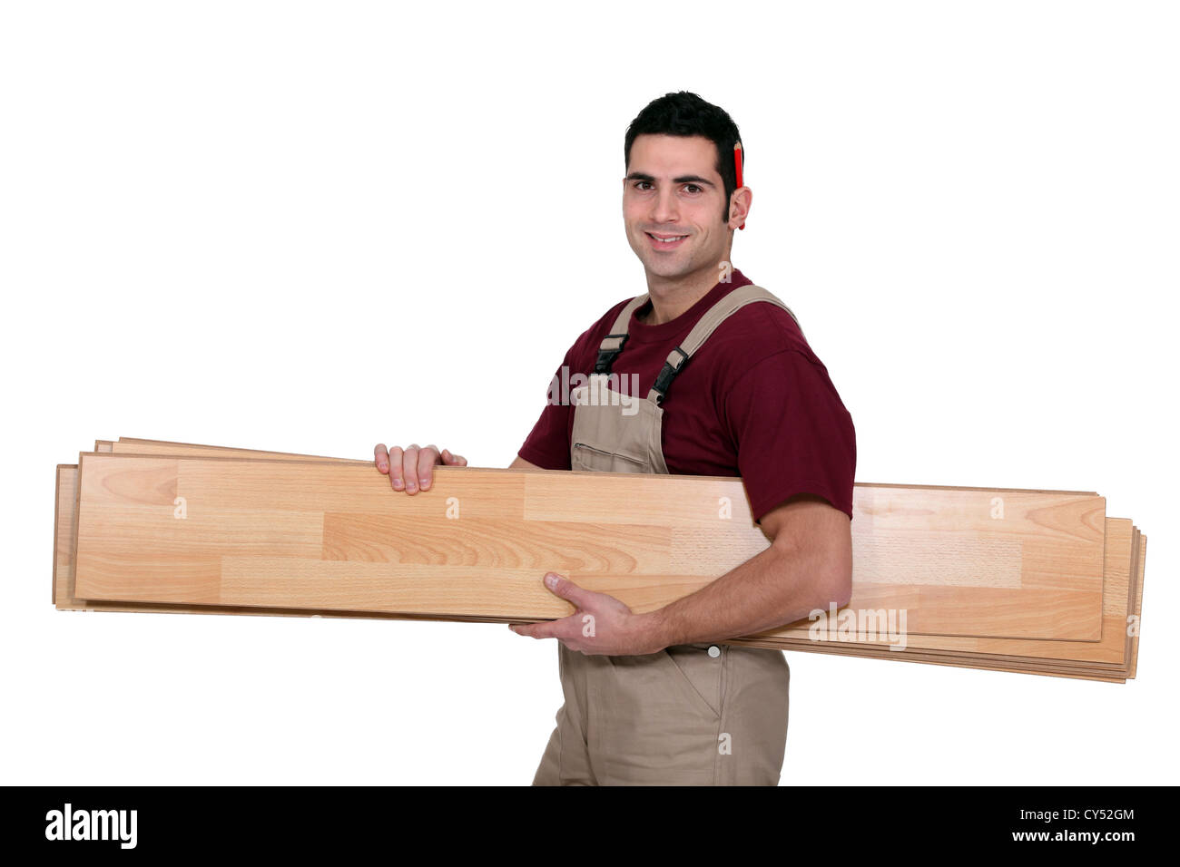 Lavoratore che trasportano tavole di legno Foto Stock