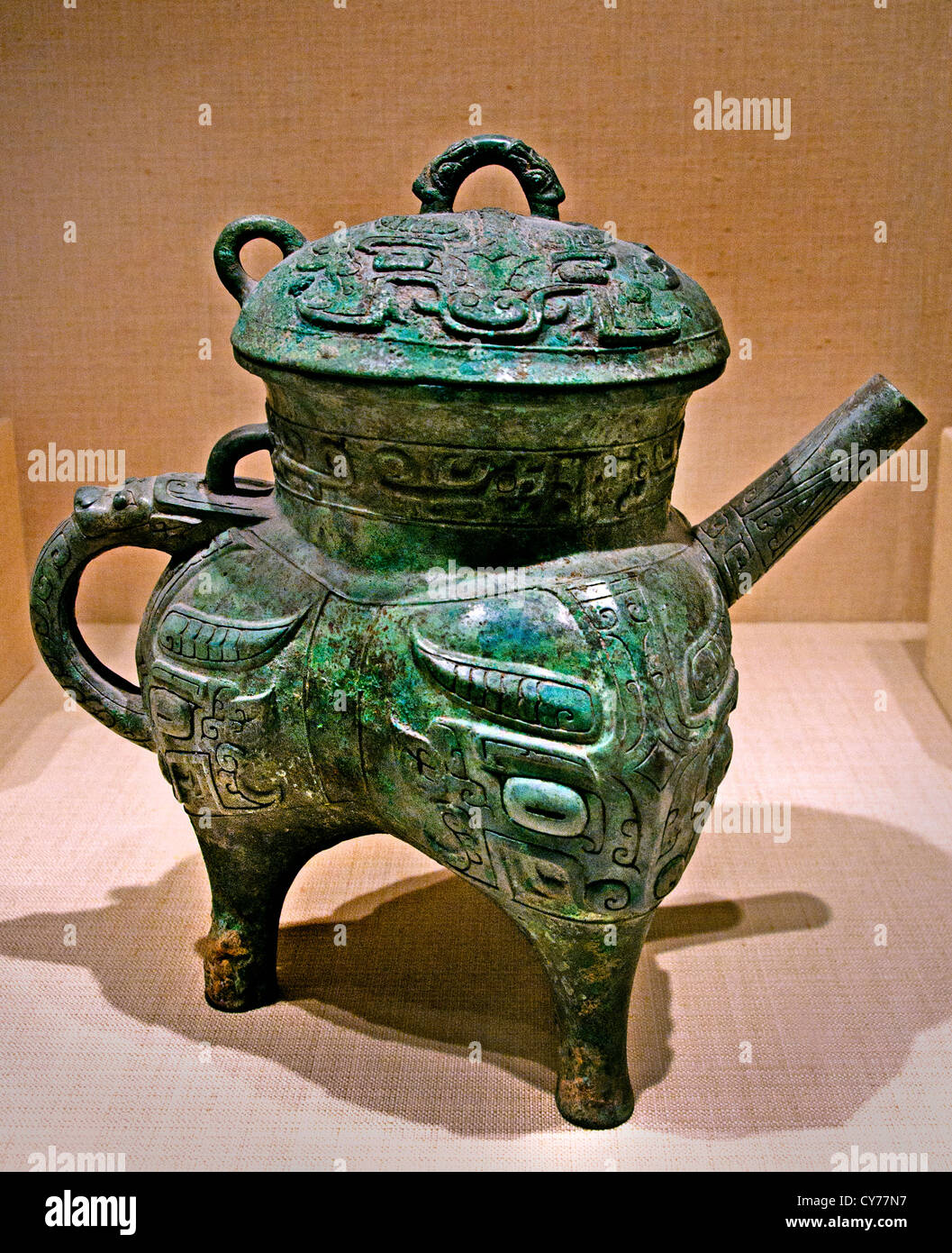 Vaso del vino rituale di bronzo arcaico cinese e copertura su gambe di treppiede, classificato nativamente come He, tarda dinastia Shang, XIII-XI secolo a.C. Foto Stock