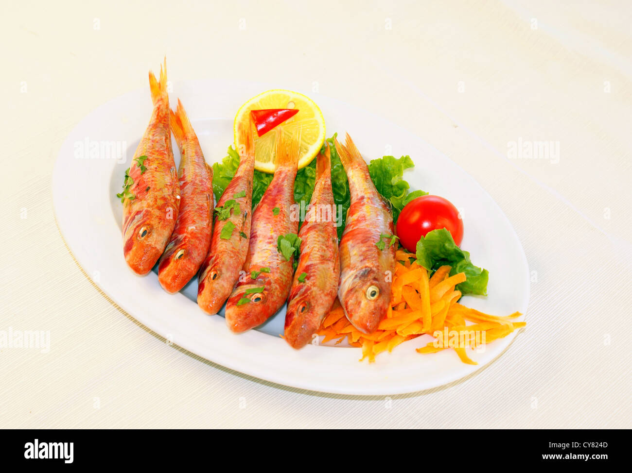 Grigliate di pesce cotto con le fette di limone e prezzemolo Foto Stock