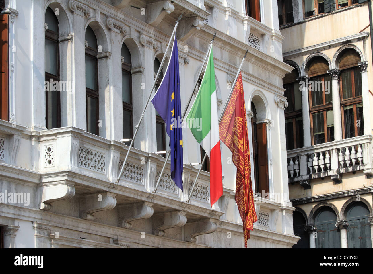 Bella Italia serie. Venezia - La perla dell'Italia. Balcone del vecchio edificio con le bandiere di Venezia, Italia, e l'UE Foto Stock