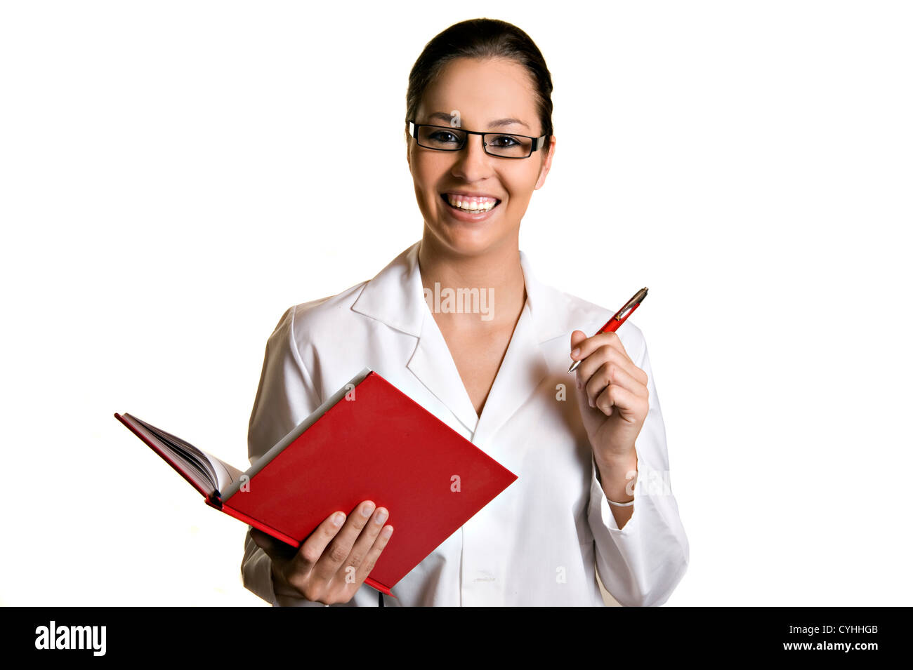 Giovane donna gentile prendendo appunti in un libro Foto Stock