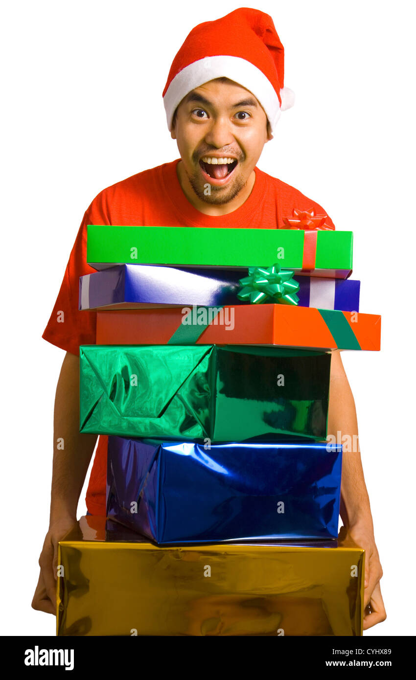 L'uomo offrendo un sacco di regali di Natale e indossando un cappello da Babbo Natale Foto Stock