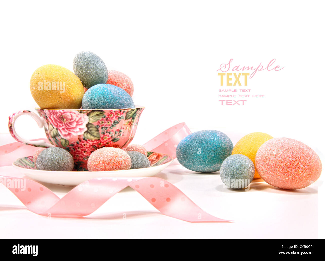 Colorate le uova in tazza da tè su bianco Foto Stock