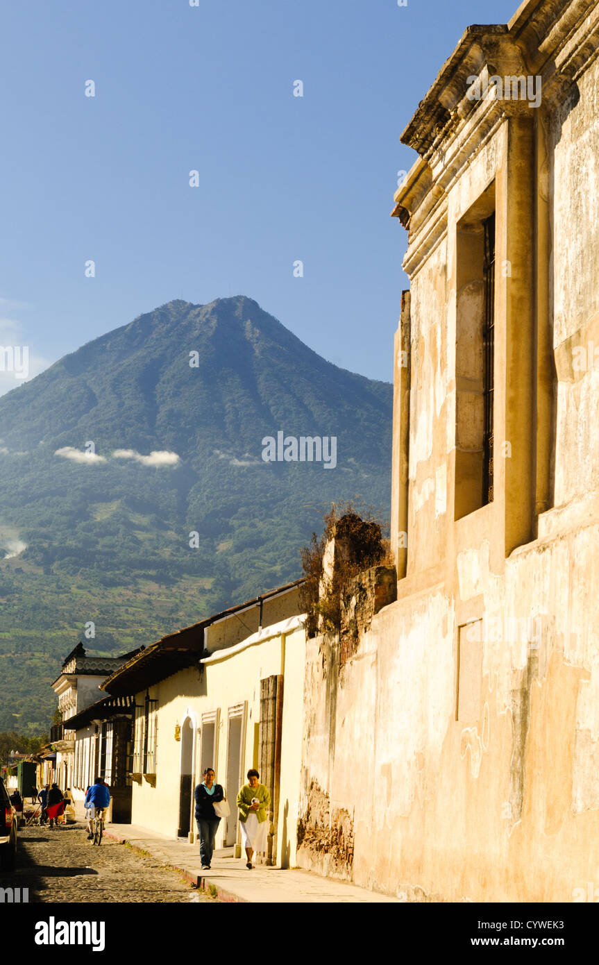 ANTIGUA GUATEMALA, Guatemala: La tradizionale architettura coloniale spagnola di Antigua si erge in primo piano, con il Volcán de Agua (o vulcano Agua) che torreggia sullo sfondo. Famosa per la sua architettura barocca spagnola ben conservata e per le numerose rovine dei terremoti, Antigua Guatemala è un sito patrimonio dell'umanità dell'UNESCO ed ex capitale del Guatemala. Foto Stock