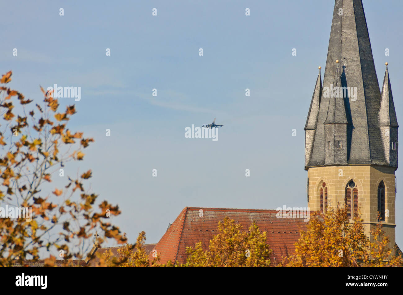 German Air Force MRCA Panavia Tornado fighter bomber jet passando una chiesa cristiana nel basso livello di volo, Germania meridionale Foto Stock
