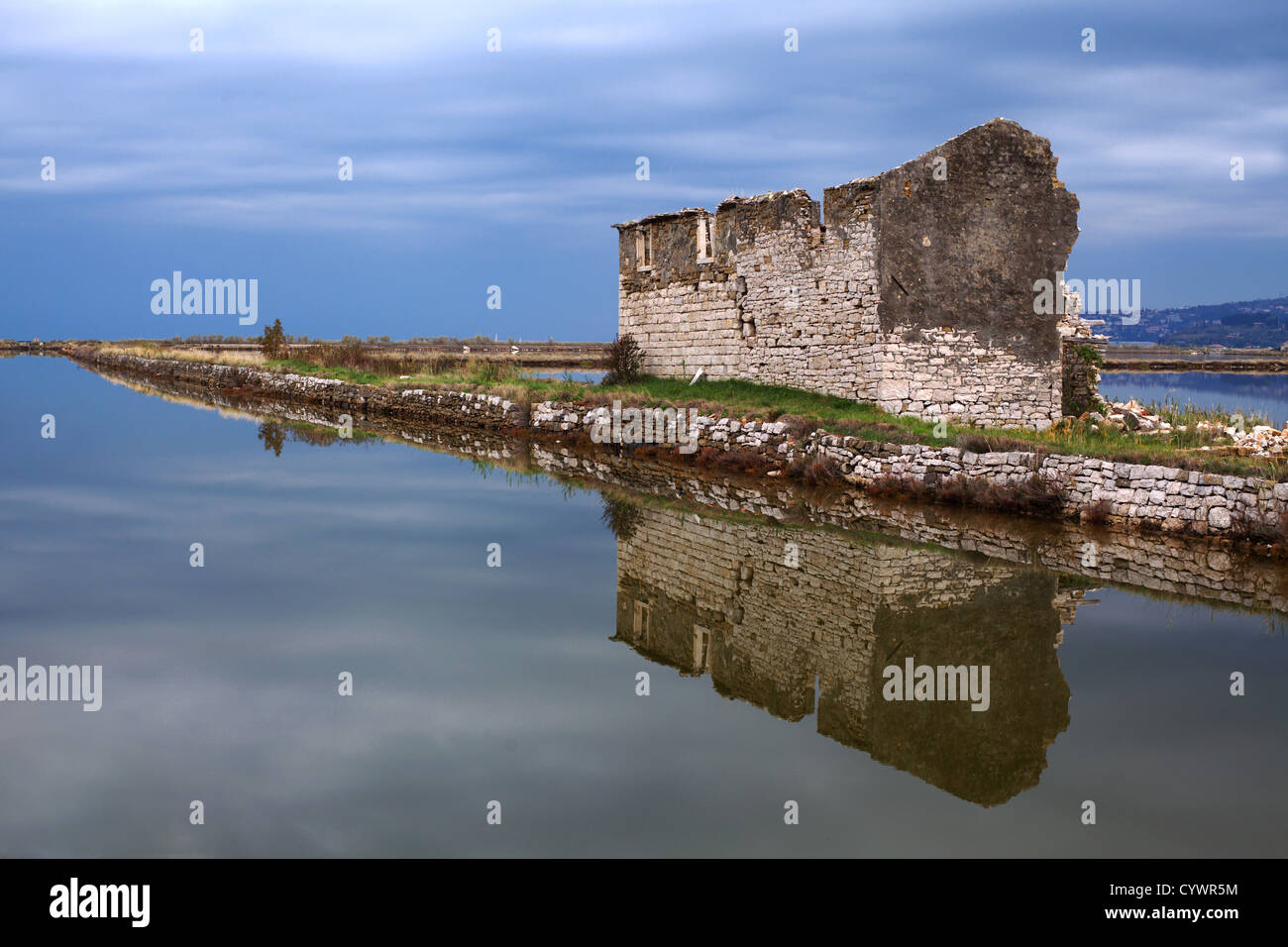 Una vecchia e dilapide salineria nelle saline pirane con riflessione in acqua. Foto Stock