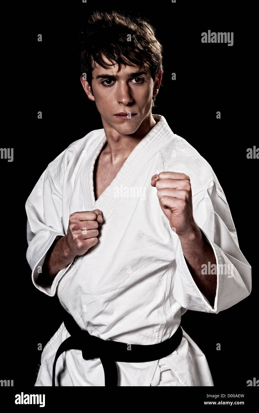 Il Karate fighter maschi giovani e ad alto contrasto su fondo nero Foto Stock
