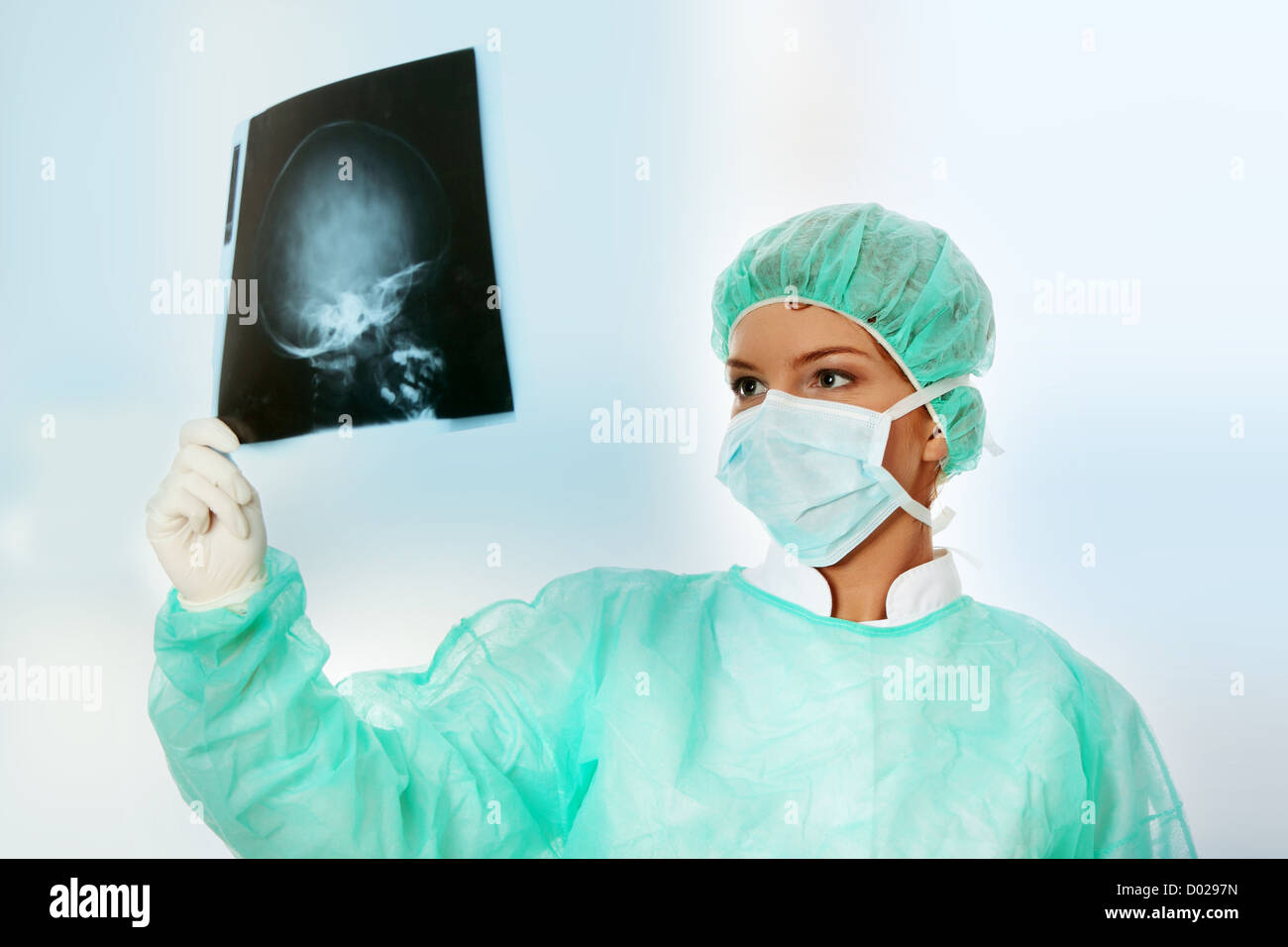 Medico donna esaminando una testa x-ray scansione fotografica. Foto Stock