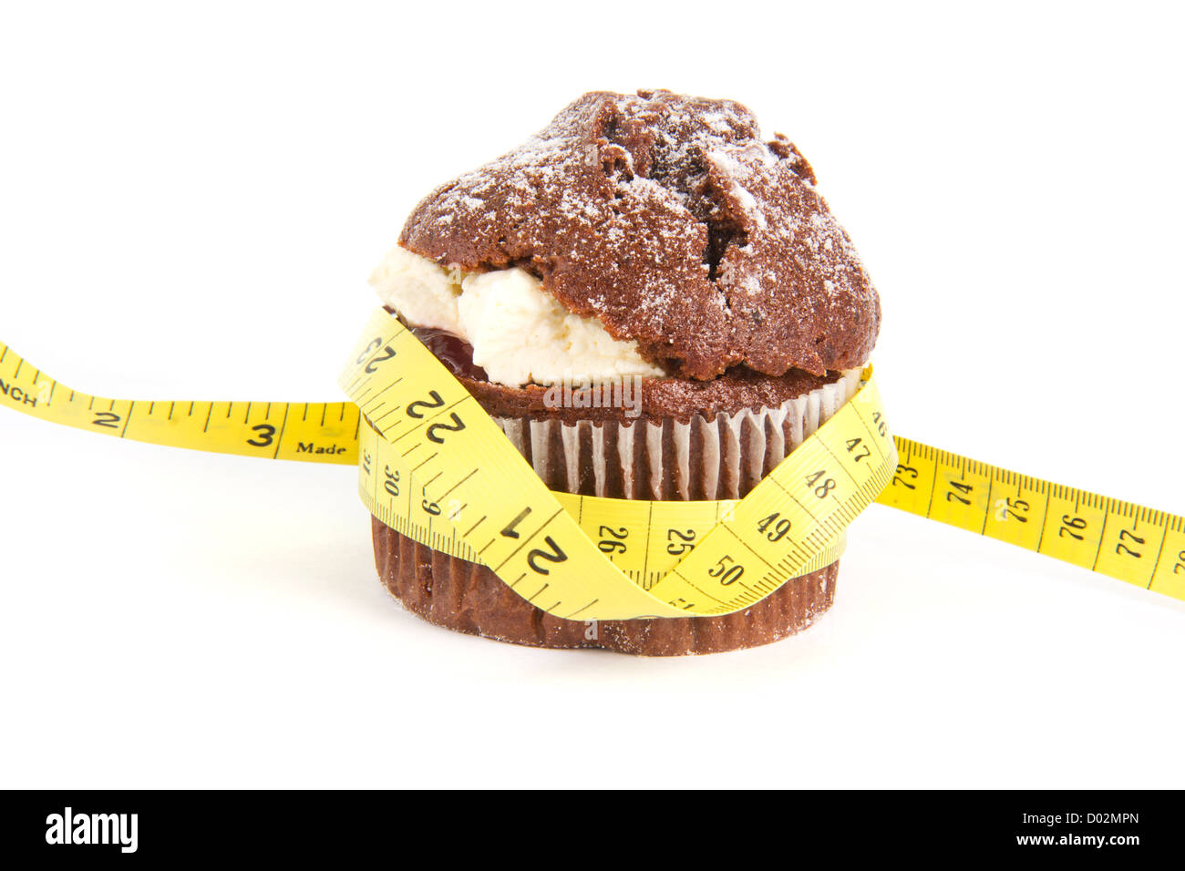 Muffin al cioccolato con una misura di nastro intorno ad esso su bianco Foto Stock