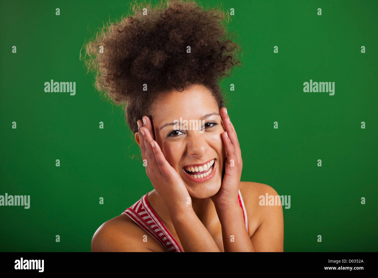 Bella donna africana di ridere su uno sfondo verde Foto Stock
