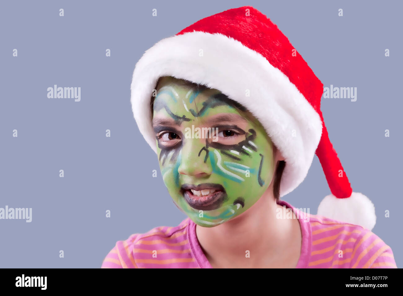 Una bambina indossa un cappello da Babbo Natale e ha volto la vernice  simile a il Grinch Foto stock - Alamy