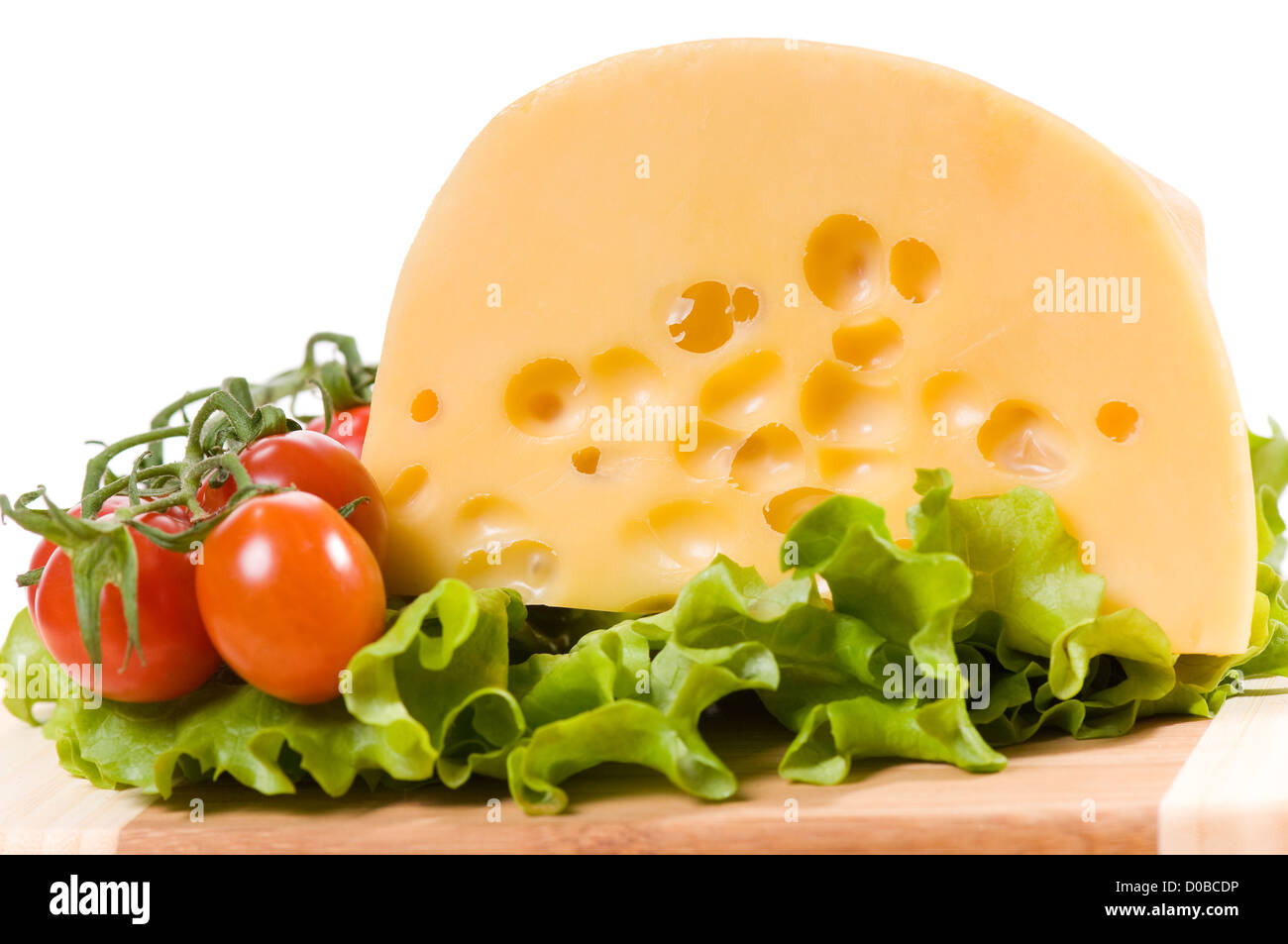 Pomodorini e formaggio giallo con fori Foto Stock