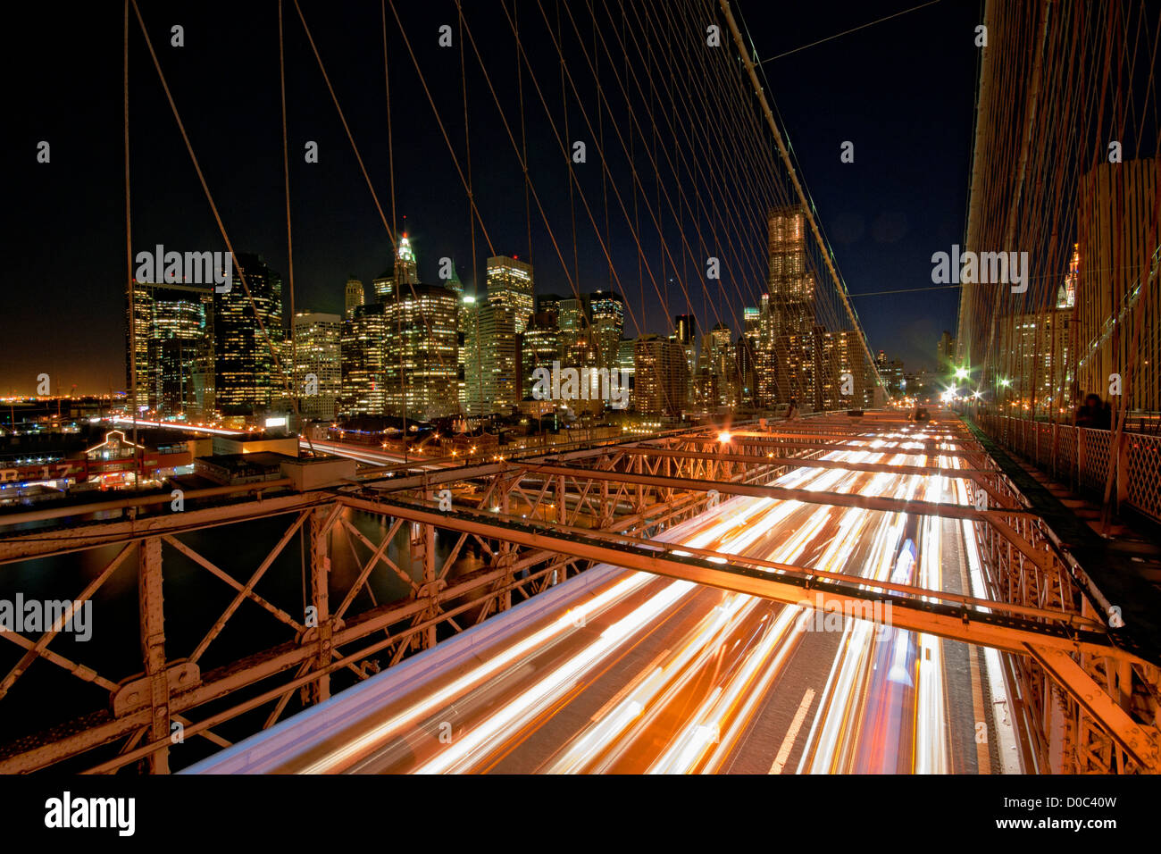 Cars driving lungo il ponte di Brooklyn voce lontano dalla skyline di Manhattan. Foto Stock