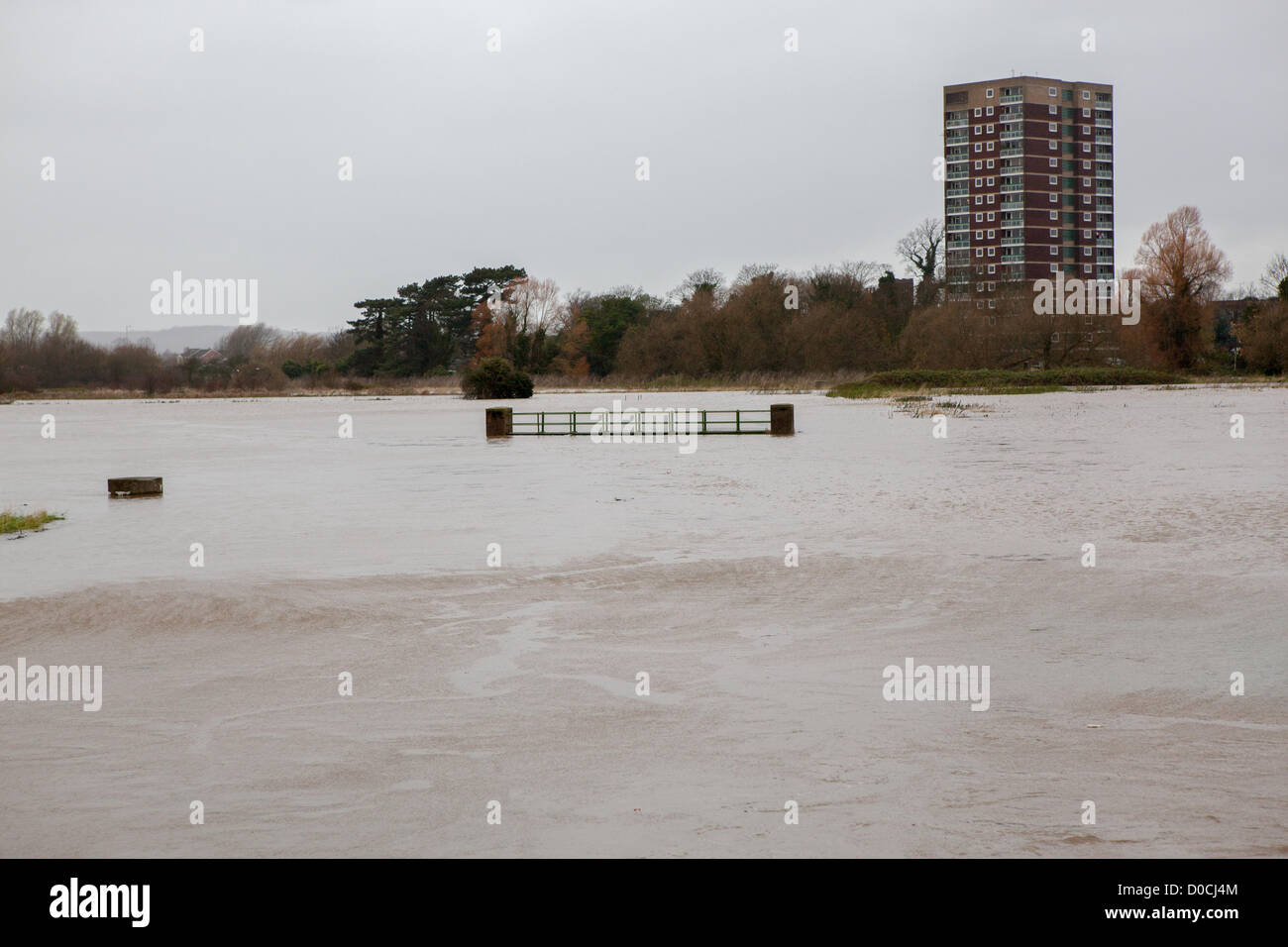 I fiumi Tame e Anker hanno rotto gli argini causando campi da alluvione in Tamworth Staffordshire. Il ponte sopra il piccolo ruscello che scorre attraverso questo campo è circondato con le acque alluvionali. Foto Stock