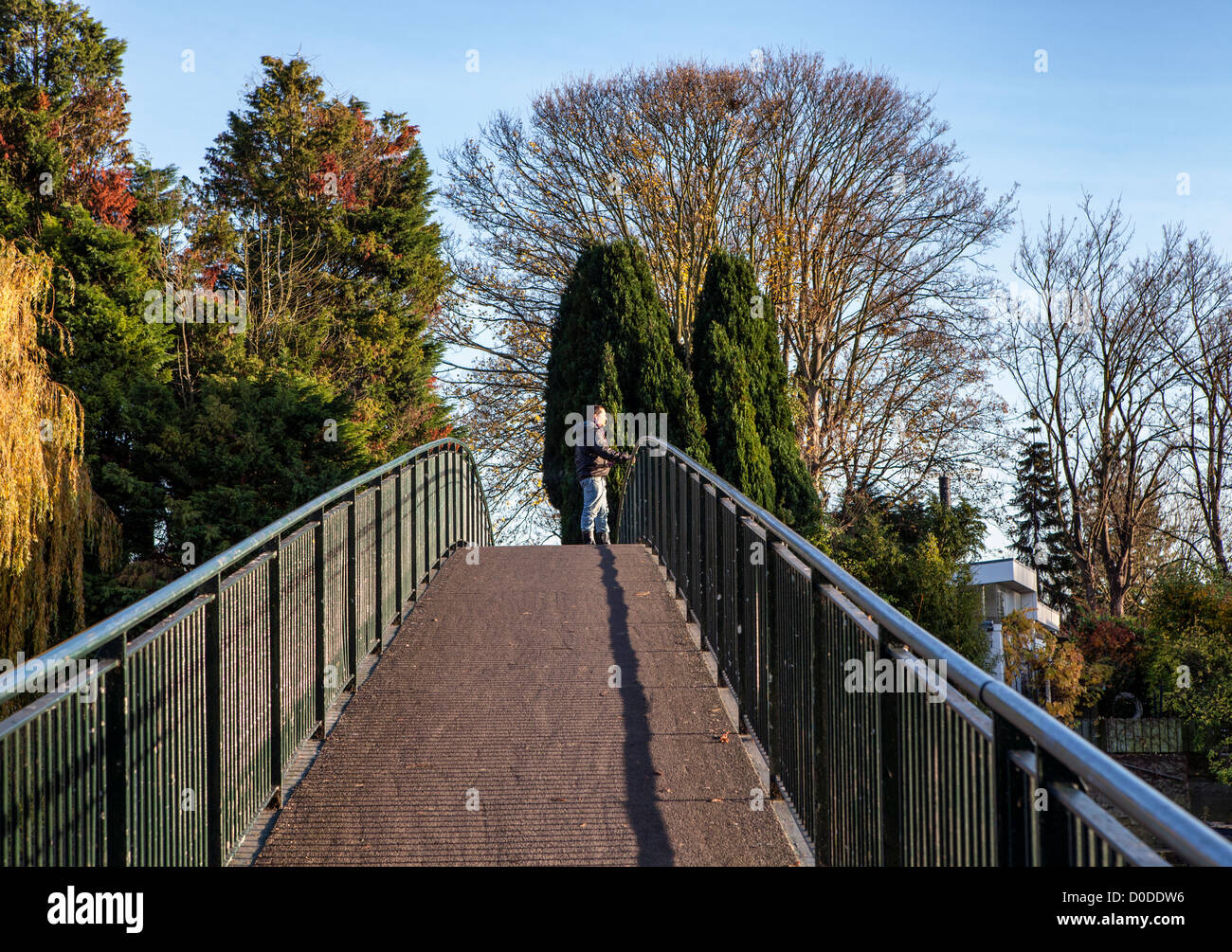 Uomo in piedi sul ponte pedonale per Eel Pie Island nel Tamigi - questo è l'unico modo per accedere all'isola.Twickenham, Greater London, UK Foto Stock