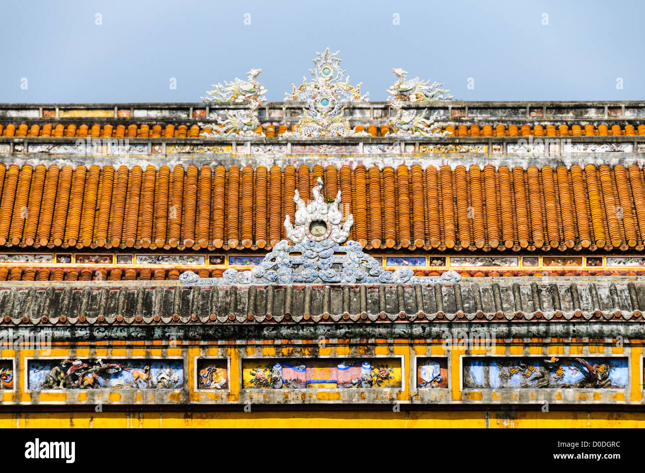 Imperial City Colorful Roof Hue Vietnam // HUE, Vietnam - Un tetto colorato presso la città Imperiale di Hue, Vietnam. Un palazzo auto-chiuso e fortificato, il complesso comprende la città Proibita viola, che era il santuario interno della casa imperiale, nonché templi, cortili, giardini e altri edifici. Gran parte della città imperiale fu danneggiata o distrutta durante la guerra del Vietnam. È ora dichiarato patrimonio dell'umanità dell'UNESCO. Foto Stock