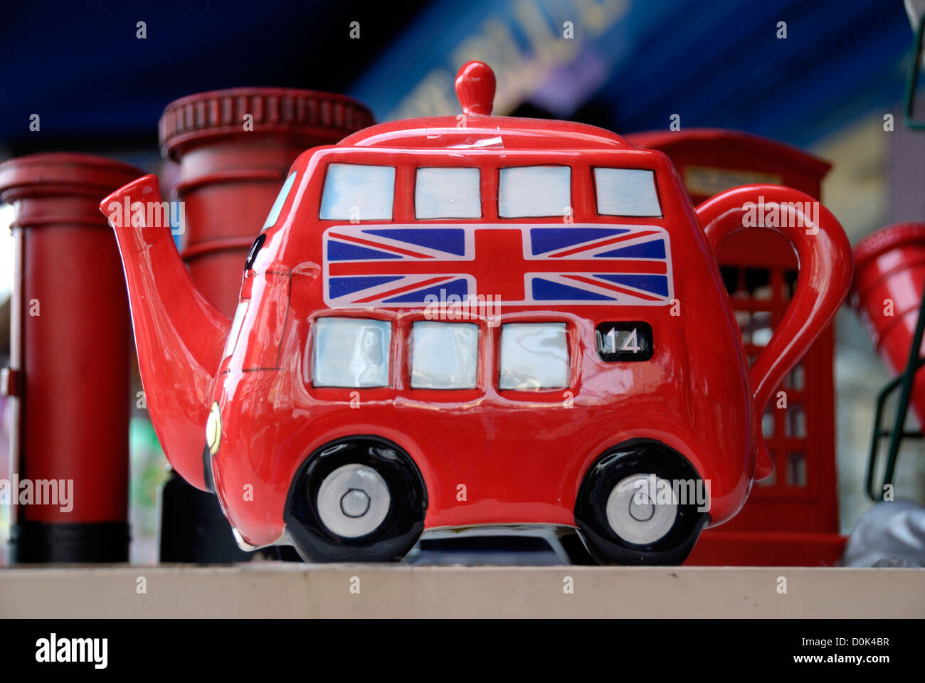 Un bus rosso a due piani teiera souvenir in vendita nel mercato di Portobello. Foto Stock