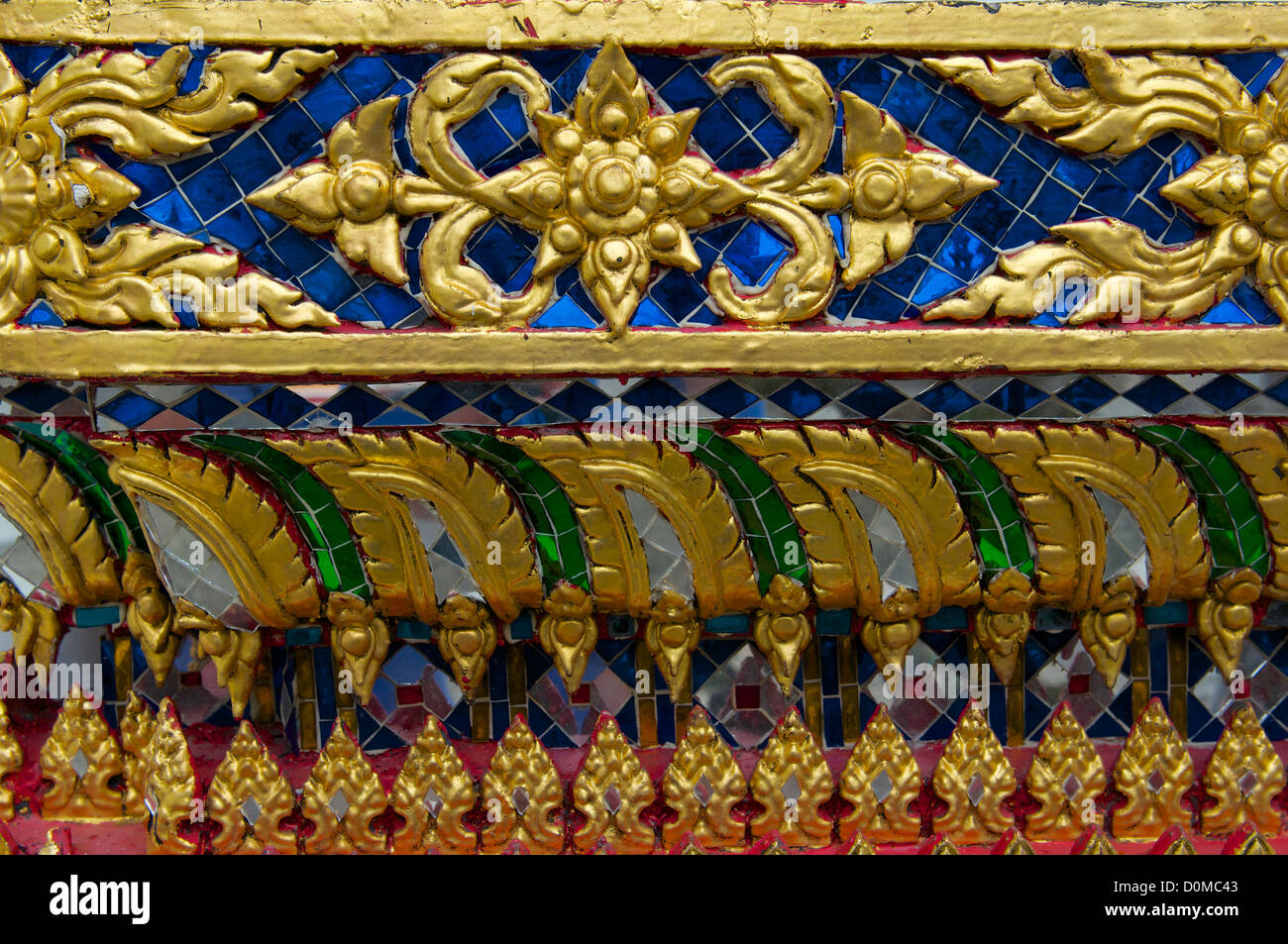 Oro e mosaici che decorano la facciata dei templi, il Grand Palace di Bangkok Foto Stock