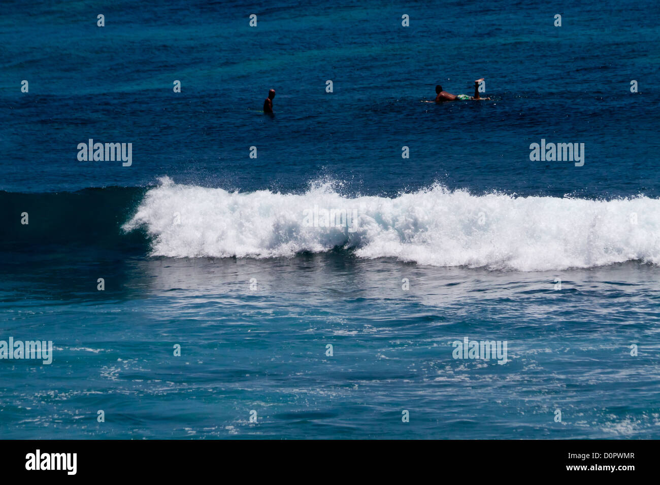 Surfers nell'Oceano Indiano a Suluban sulla spiaggia di Bali, Indonesia Foto Stock