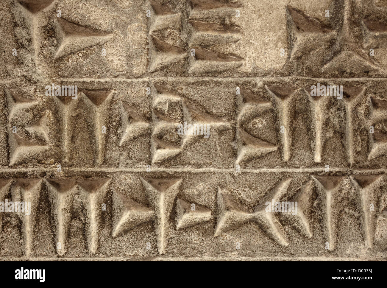 Il cuneiforme scrittura antica su sfondo di pietra Foto Stock