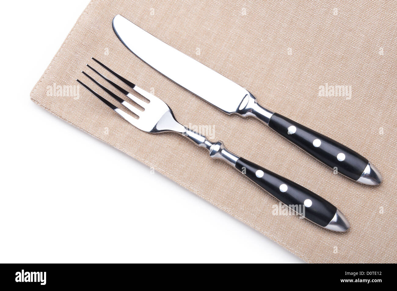 Forchetta e coltello su un tovagliolo di lino Foto Stock