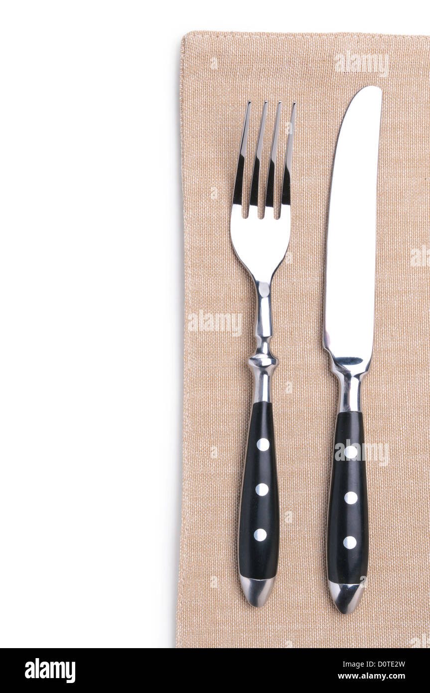 Forchetta e coltello su un tovagliolo di lino Foto Stock