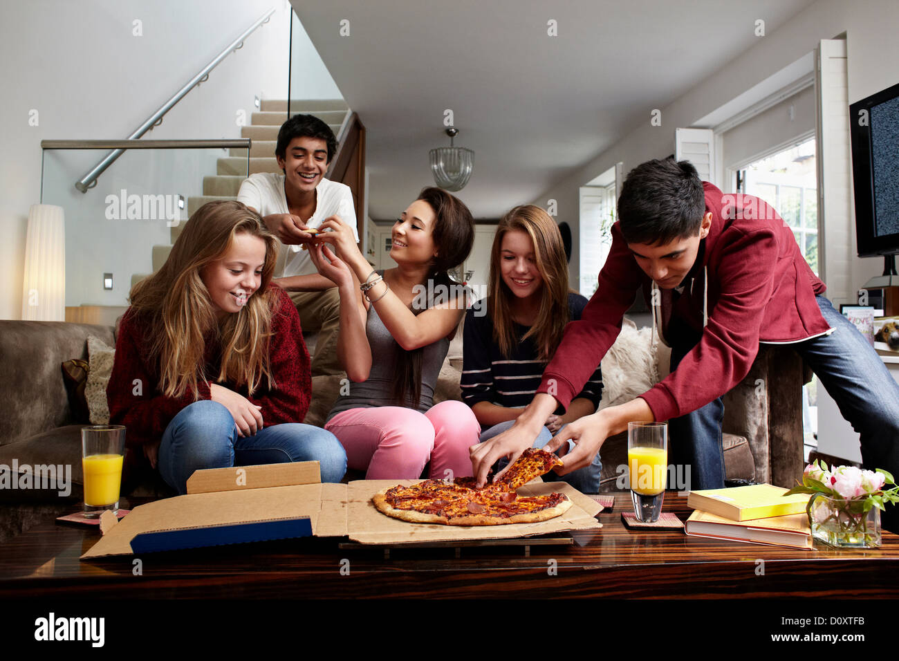 Gli adolescenti avente take away pizza Foto Stock