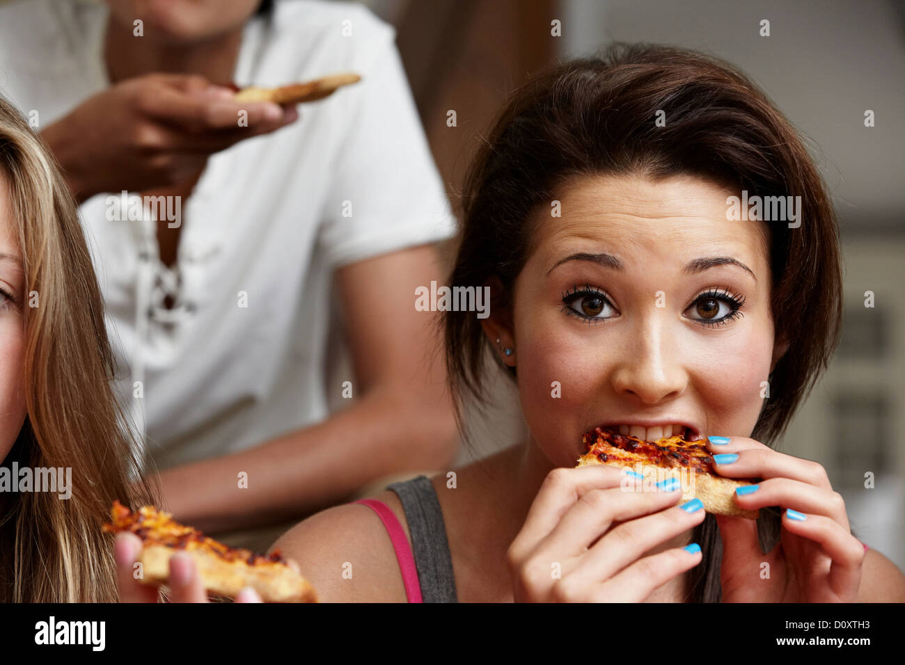 Ragazza adolescente mangiare la pizza Foto Stock