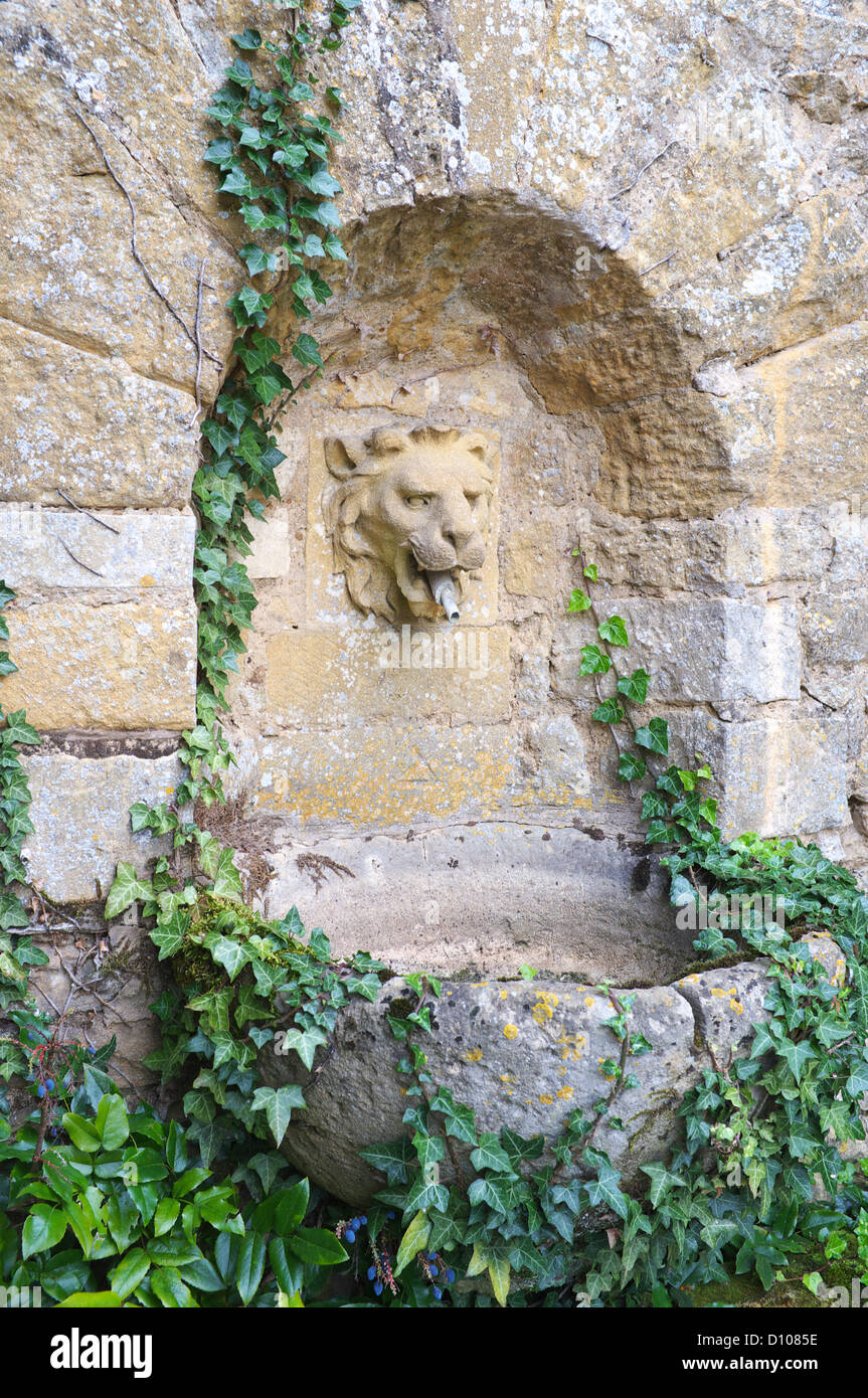 Cotswold giardino di pietra testa Leone fontana, Gloucestershire, England, Regno Unito Foto Stock