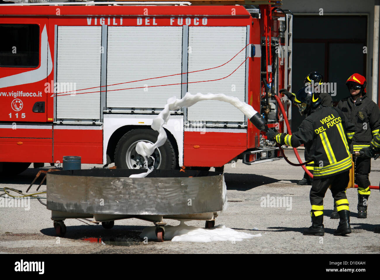 Vigili del Fuoco italiano estinguere un incendio simulato durante un esercizio di loro Firehouse Foto Stock