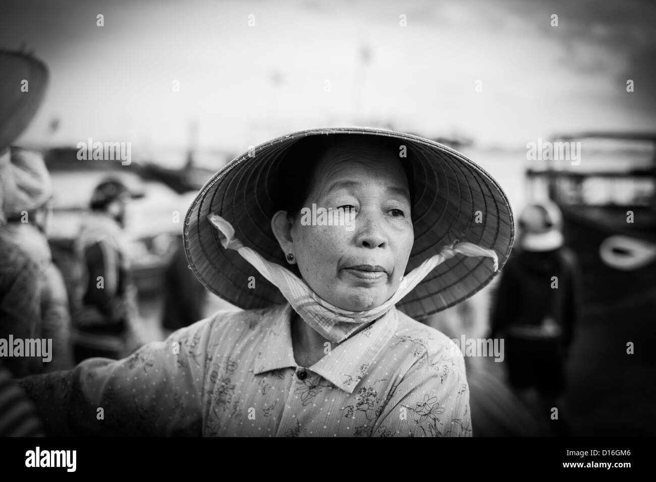 Bianco e nero ritratto di una donna vietnamita che indossa un tradizionale cappello di bambù Foto Stock