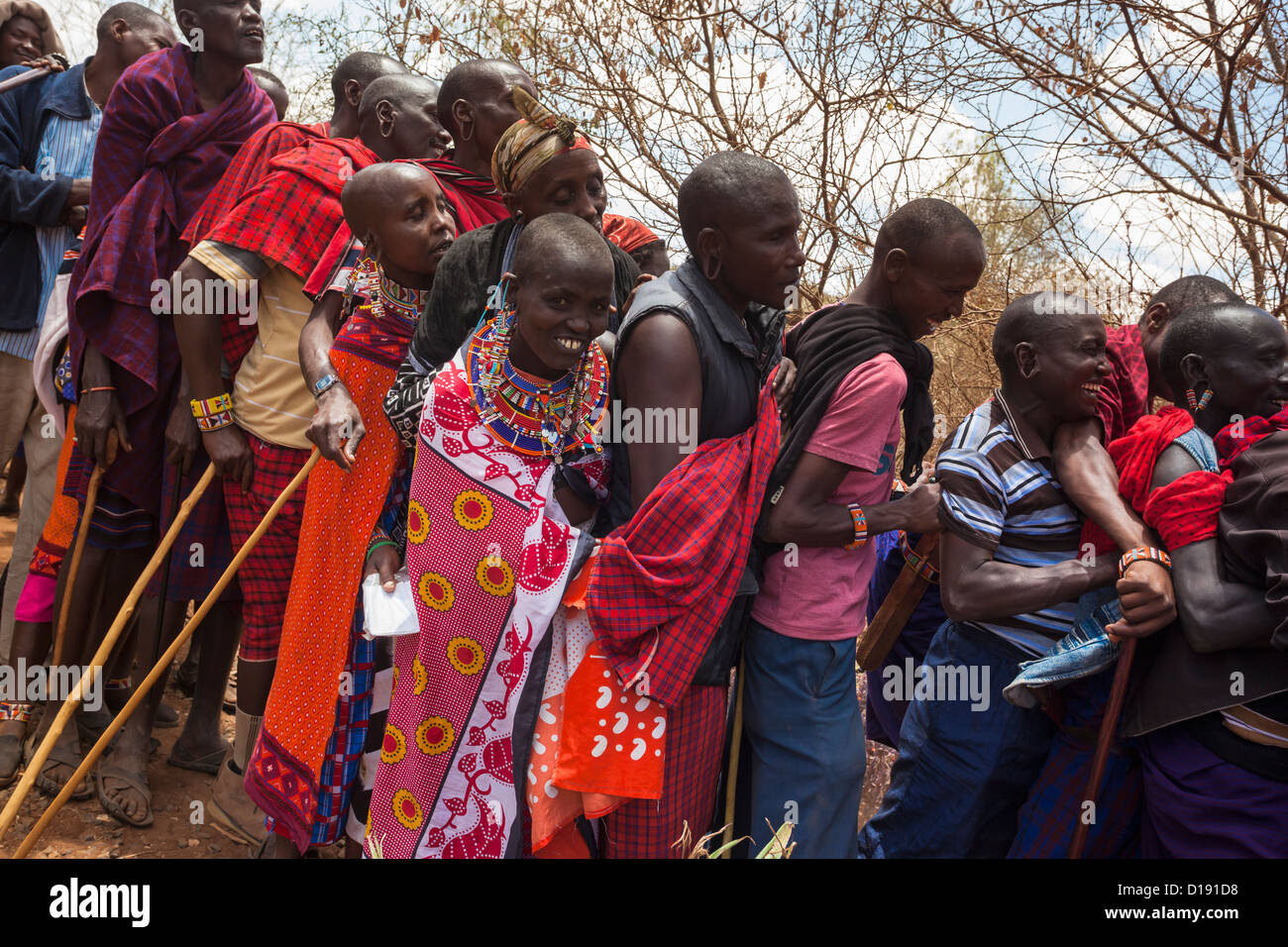 Gli abitanti di un villaggio Masai formano una linea al predatore del fondo di compensazione di giorno di paga, Gruppo Mbirikani Ranch, Kenya, Africa Foto Stock
