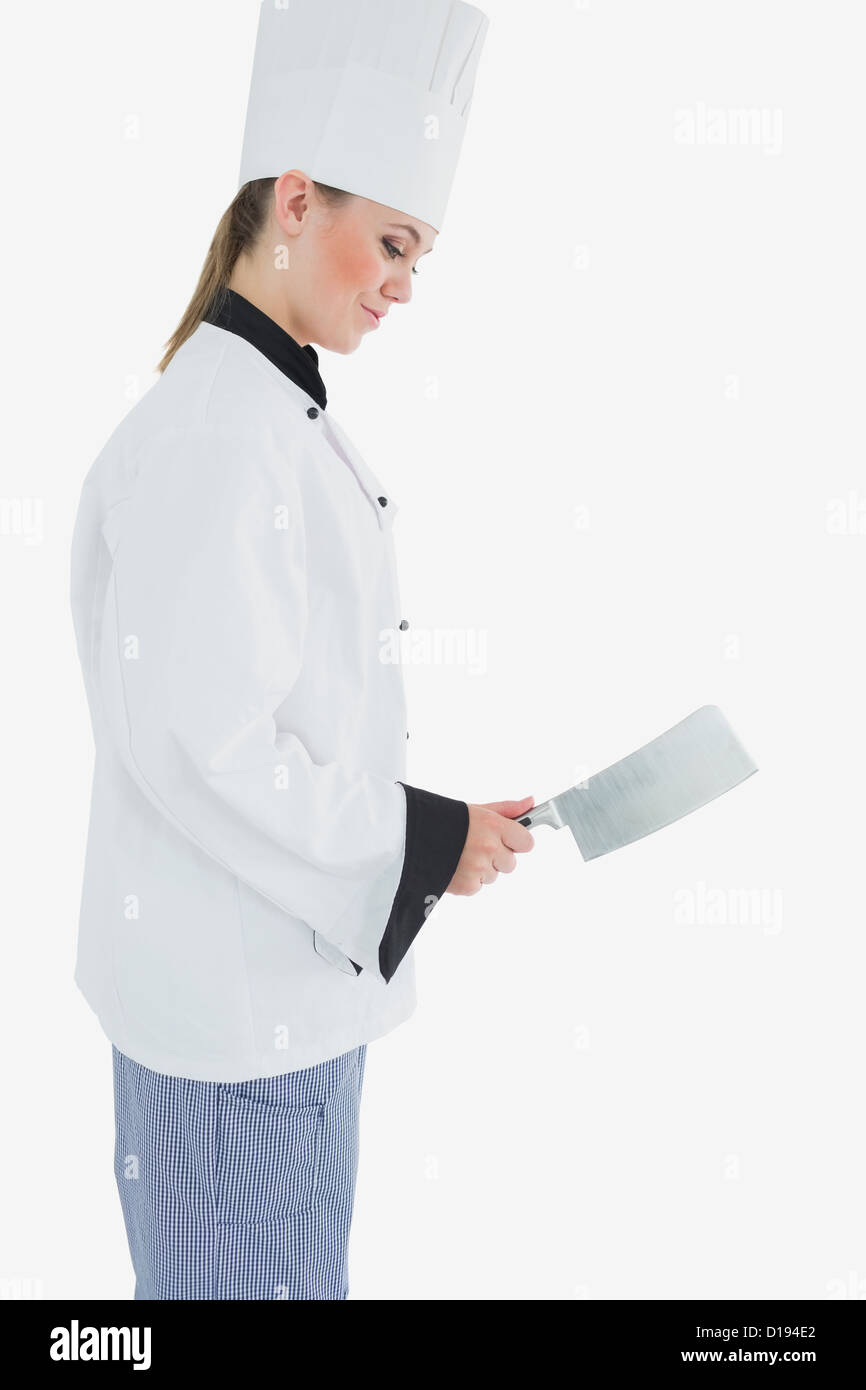 Lo Chef holding mannaia di carne come sorride Foto Stock