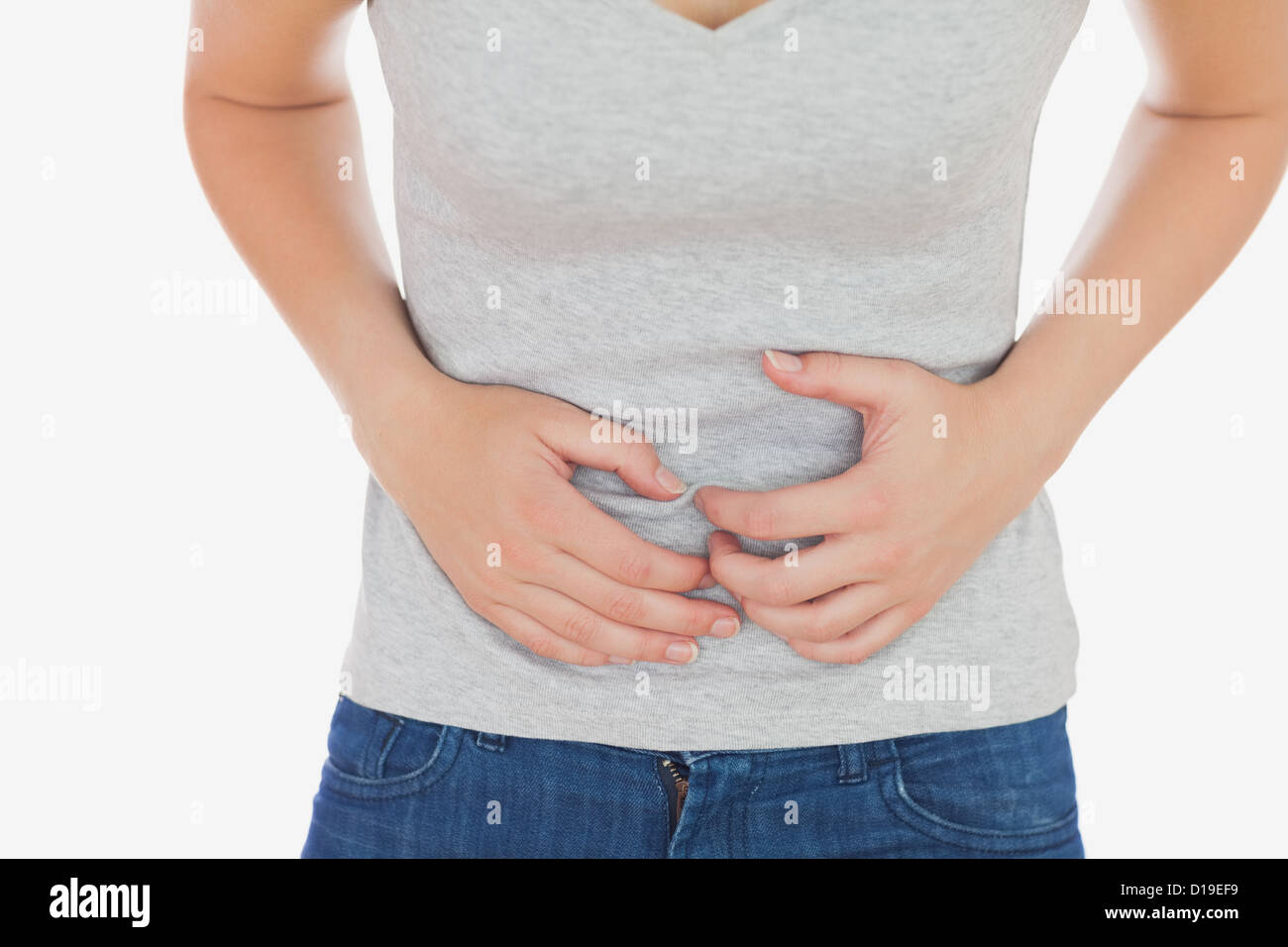 Donna in casuals affetti da mal di stomaco Foto Stock