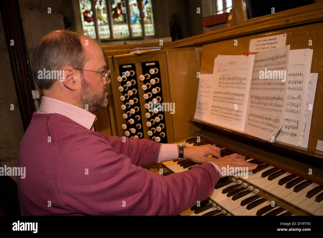 Chiesa organista giocando alla chiesa di San Lorenzo, Alton, HAMPSHIRE, Regno Unito. Foto Stock