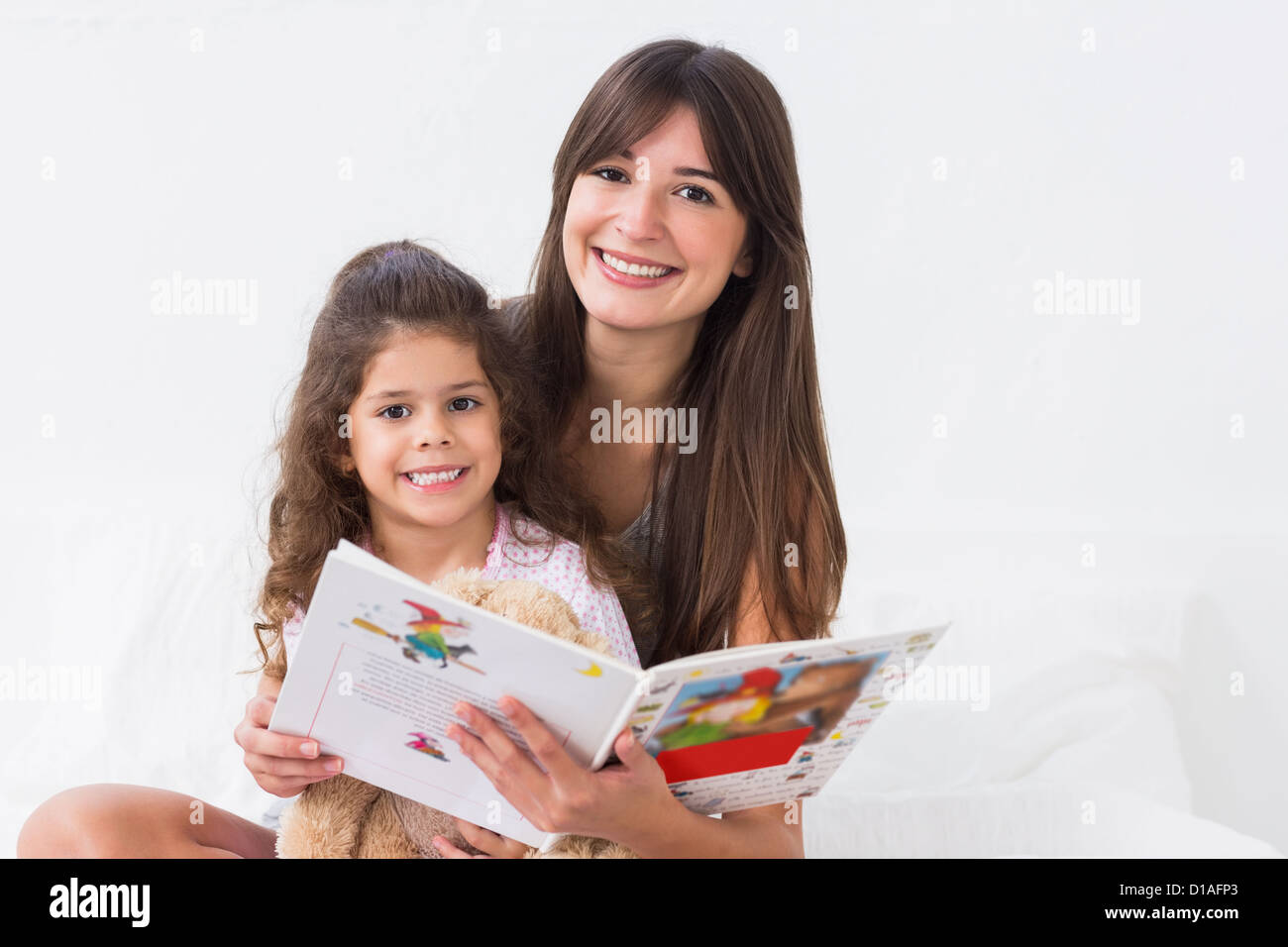 Felice madre e figlia con storybook Foto Stock