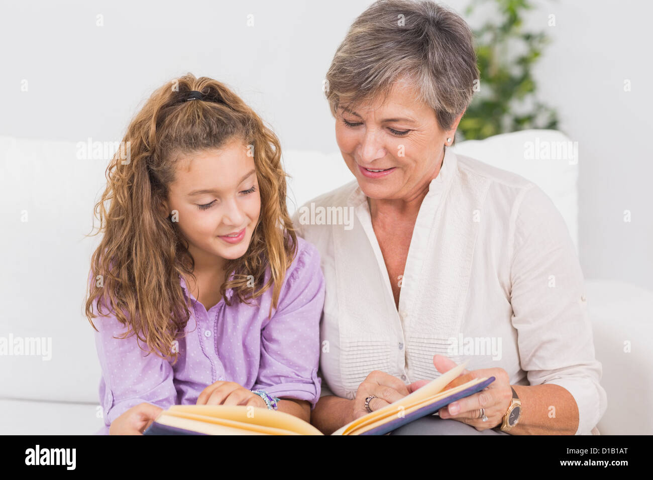 Ritratto di un bambino e la nonna la lettura di un libro Foto Stock